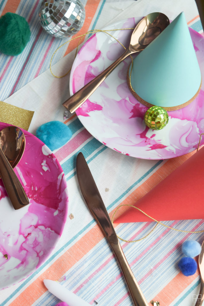 Make your own marbleized plates in under 2 minutes using nail polish! These Pottery Barn inspired plates are easy to customize and sure to wow at your next dinner party.