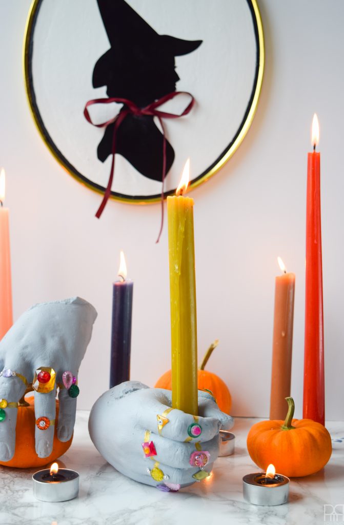 DIY Grave Robber Hands for a spooky piece of Halloween decor-Using plaster hand casts, paint, and little gemstones you can make some spooky things!