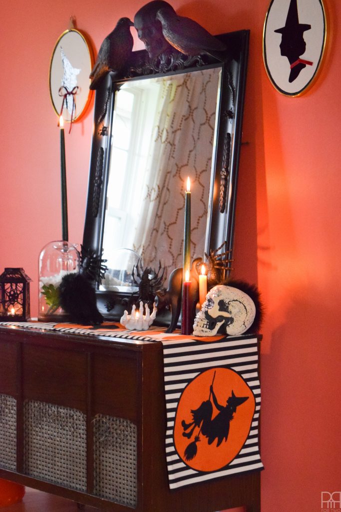 Create a show-stopping piece of Halloween Decor for your entryway using items from the dollar store and an existing mirror.