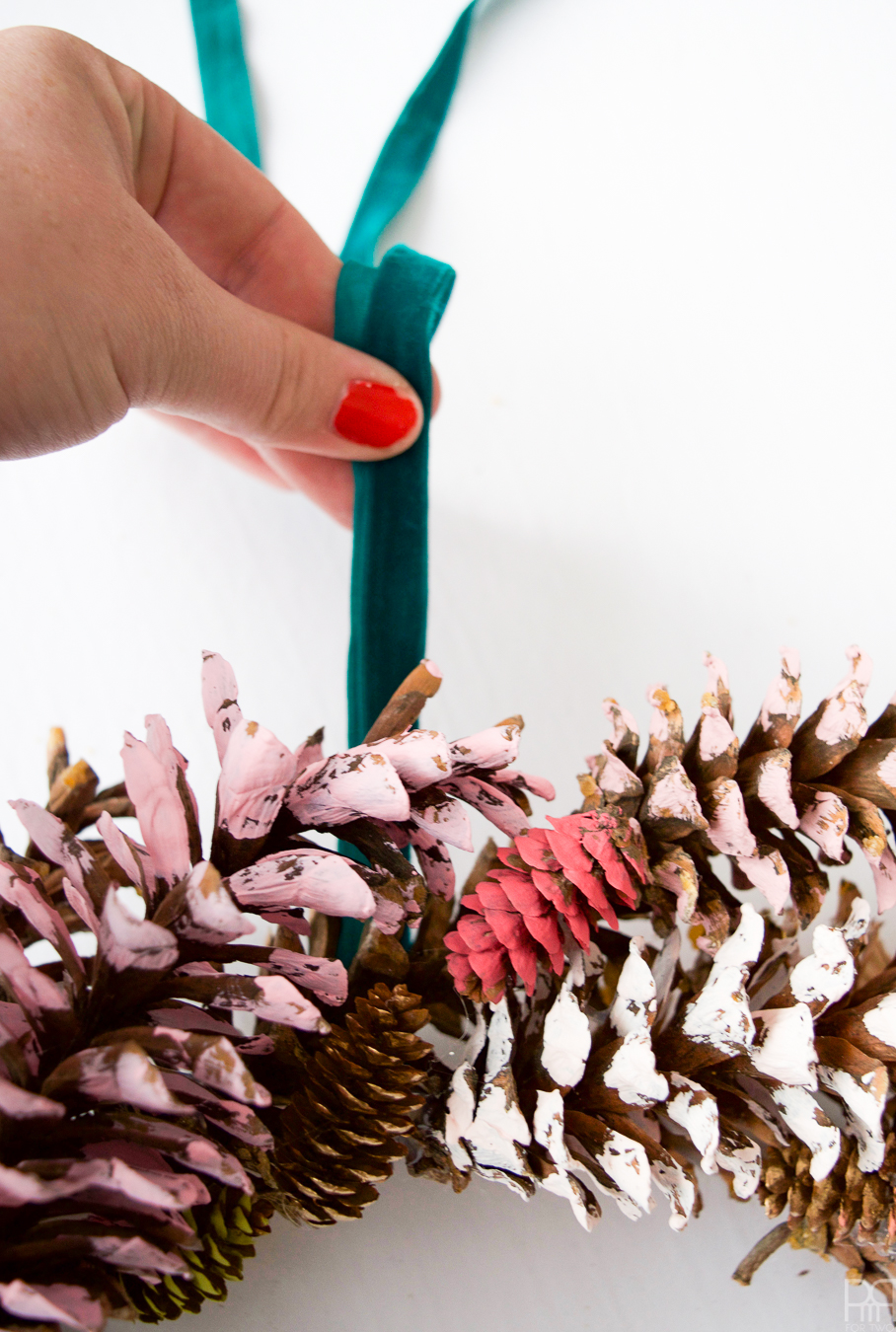 I painted pinecones in beautiful on-trend hues, and gluing them to a wreath - easy as 1-2-3!