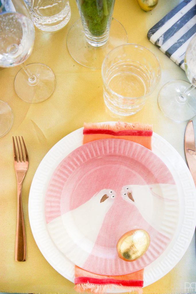 Using Krylon Spray Paint I created a colourful tablecloth at the centre of my eclectic & colourful easter table decor. Florals, bunnies and more abound in this colourful tablescape.