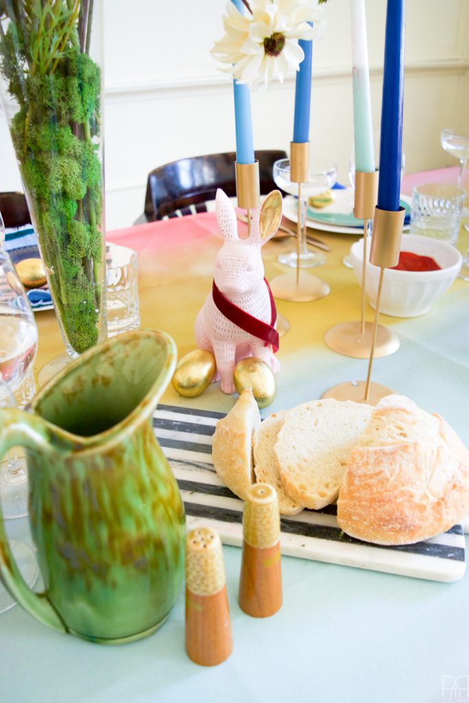 Using Krylon Spray Paint I created a colourful tablecloth at the centre of my eclectic & colourful easter table decor. Florals, bunnies and more abound in this colourful tablescape.