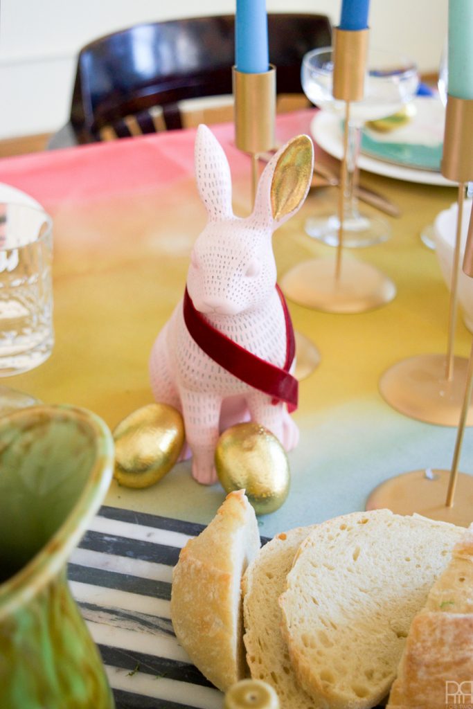 Using Krylon Spray Paint I created a colourful tablecloth at the centre of my eclectic & colourful easter table decor. Florals, bunnies and more abound in this colourful tablescape.