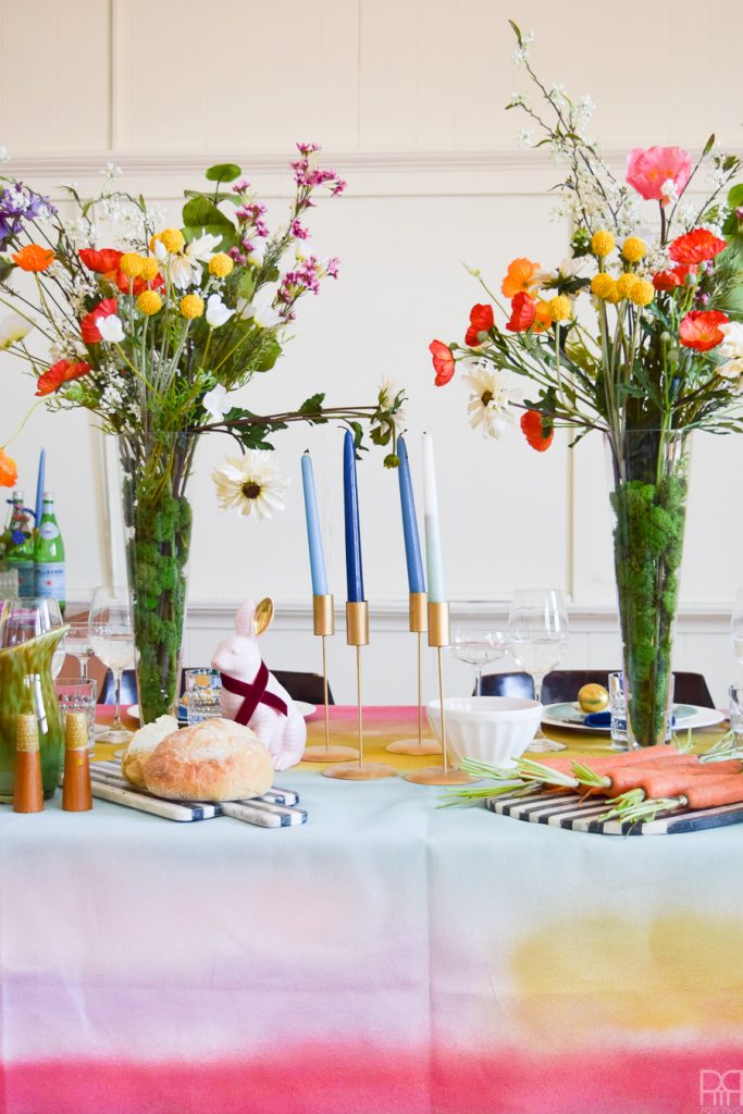 Using Krylon Spray Paint I created a colourful tablecloth at the centre of my eclectic & colourful easter table decor. Florals, bunnies and more abound in this colourful tablescape.