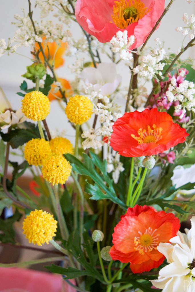 Using Krylon Spray Paint I created a colourful tablecloth at the centre of my eclectic & colourful easter table decor. Florals, bunnies and more abound in this colourful tablescape.