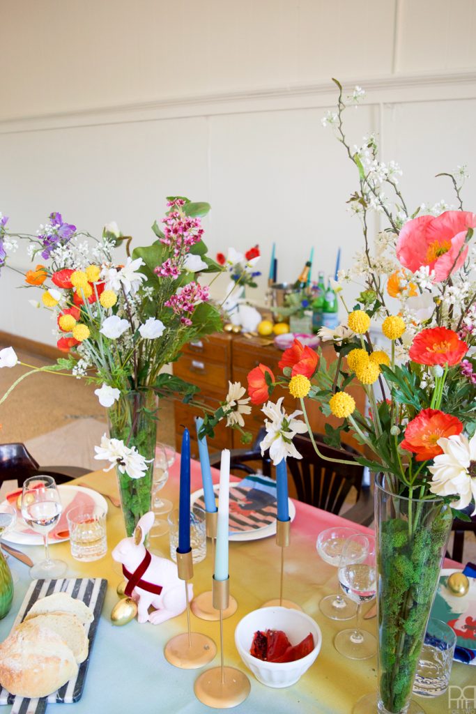 Using Krylon Spray Paint I created a colourful tablecloth at the centre of my eclectic & colourful easter table decor. Florals, bunnies and more abound in this colourful tablescape.