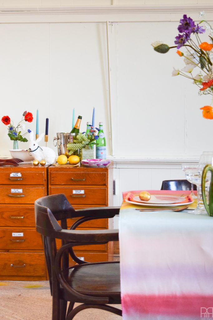 Using Krylon Spray Paint I created a colourful tablecloth at the centre of my eclectic & colourful easter table decor. Florals, bunnies and more abound in this colourful tablescape.