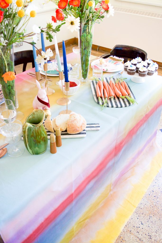 Using Krylon Spray Paint I created a colourful tablecloth at the centre of my eclectic & colourful easter table decor. Florals, bunnies and more abound in this colourful tablescape.