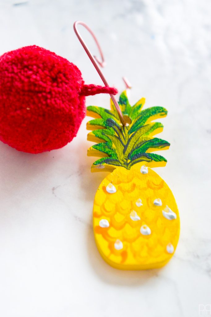 Make your own pineapple wine glass charms using acrylic paint and cute pom-poms. These cuties will look good with any glass of wine, rose, or other! 