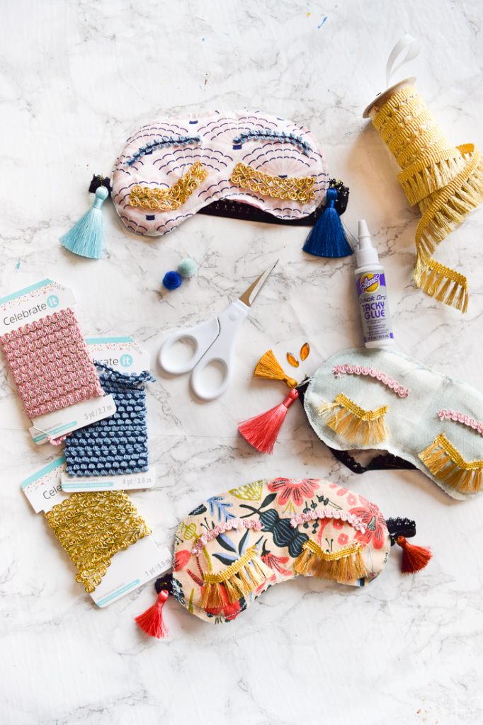 Make your own DIY Holly Golitghtly Sleep Masks with the supplies you may already have. Colourful tassels and pom poms, fringe, and fabric scraps are all you need for these fun sleep masks that would also make a great gift.