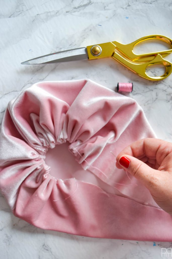 sewing a pink velour pouch and gold scissors