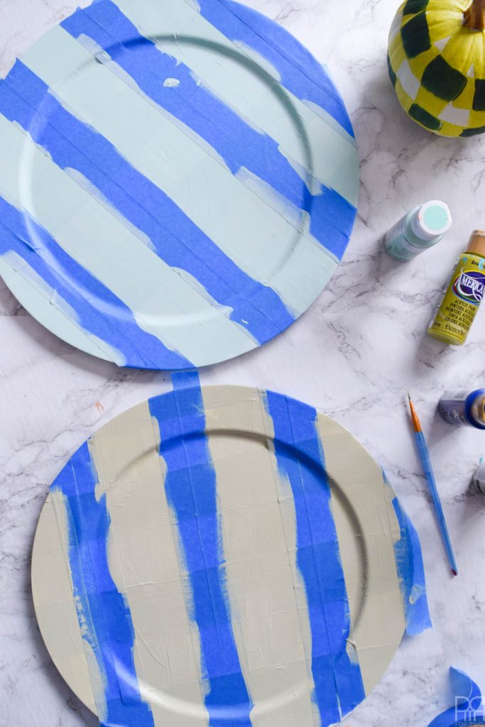 Using Americana's chalky finish paint you can cover-up ugly plastic plates and create beautiful painted plaid chargers.