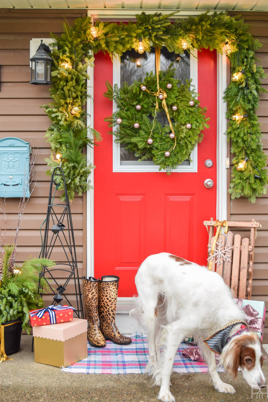 We're off to a good start over here with my colourful Christmas front porch. A bright red door and Yuletide greenery are the perfect touch. #curbappeal #christmasporch #homefortheholidays 