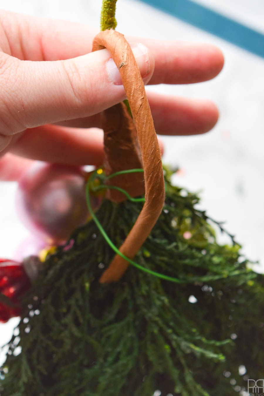 Create perfect Juniper Berry Christmas Swags using Afloral stems and ornaments. They're the perfect decor for your kitchen or bathroom, and don't take up as much room as a wreath.