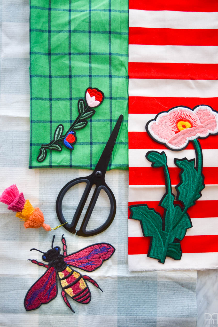 Inspired by the hit runway fashion trend, these DIY Gucci Inspired Tea Towels are easier to make than you'd think! Grab some fun fabric prints and these affordable iron-on patches, and you're ready to go!