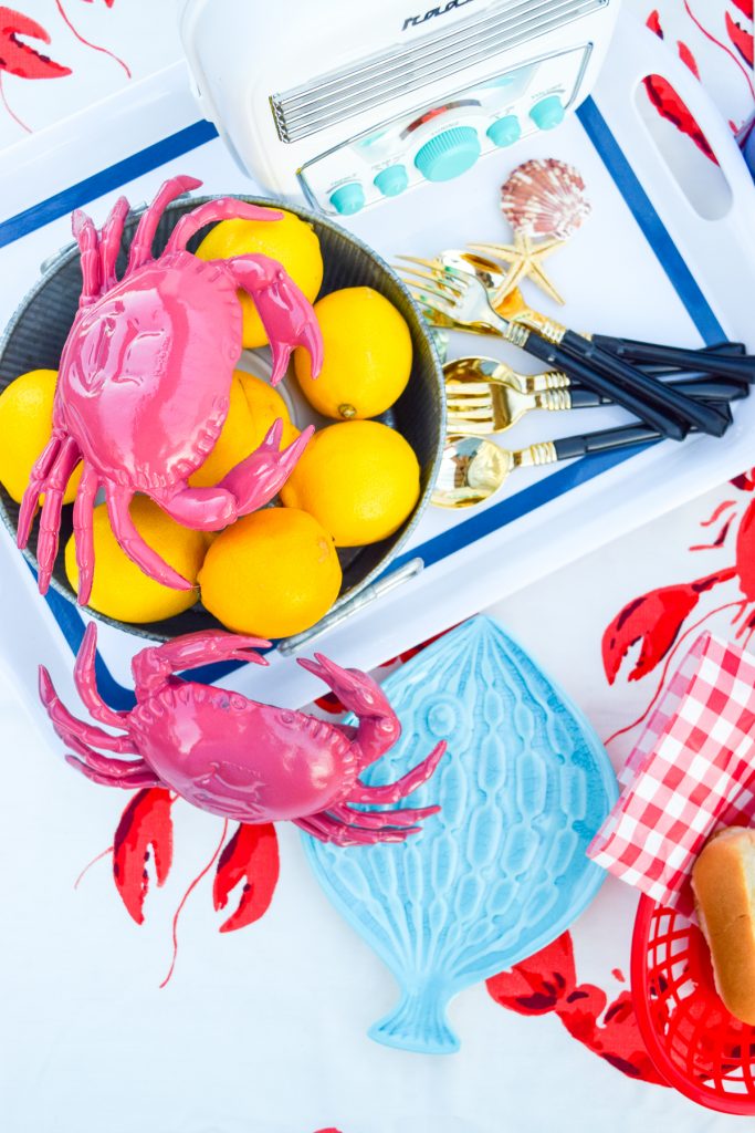 top down view of pink crabs, lemons and cutlery