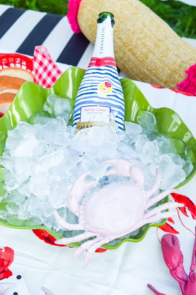 champagne bottle on ice with a pink crab