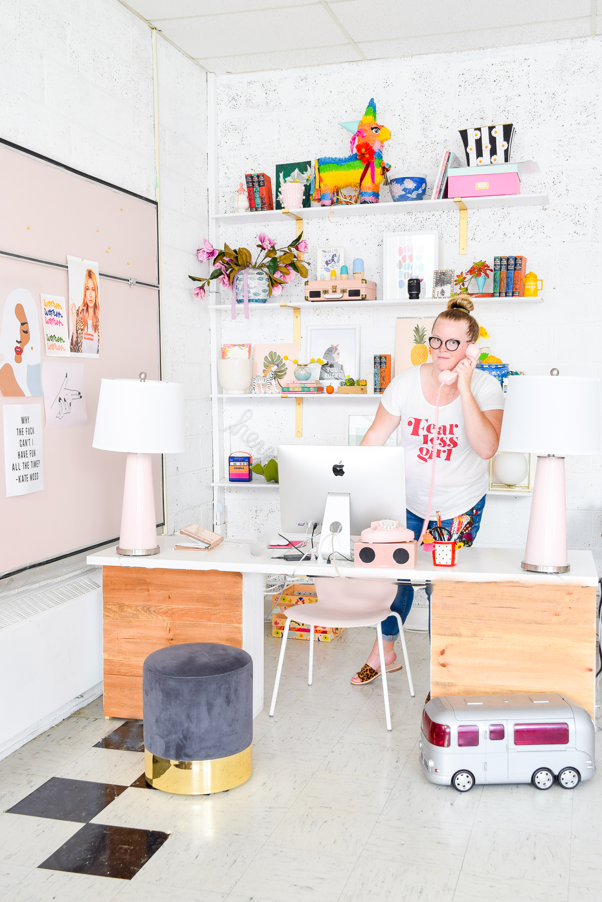Who would have thought that gold shelf brackets would have kicked-off a pink & gold office revamp? Full of bright colours, gold, playful touches and accessories from women owned stores, what's not to love? woman standing behind a desk on the phone