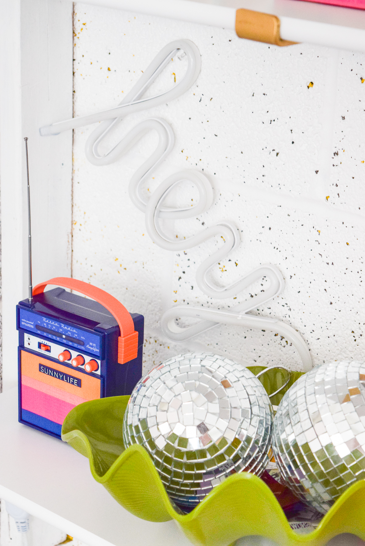 Who would have thought that gold shelf brackets would have kicked-off a pink & gold office revamp? Full of bright colours, gold, playful touches and accessories from women owned stores, what's not to love? discoballs in a green clam shell bowl
