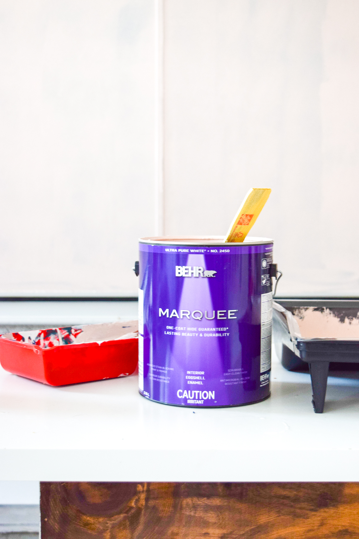 Who would have thought that gold shelf brackets would have kicked-off a pink & gold office revamp? Full of bright colours, gold, playful touches and accessories from women owned stores, what's not to love? can of marquee BEHR paint on a desk