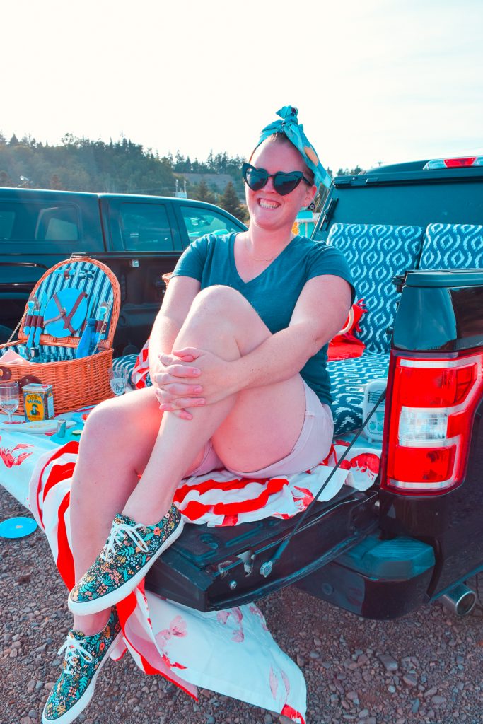 woman sitting on the gain of a truck