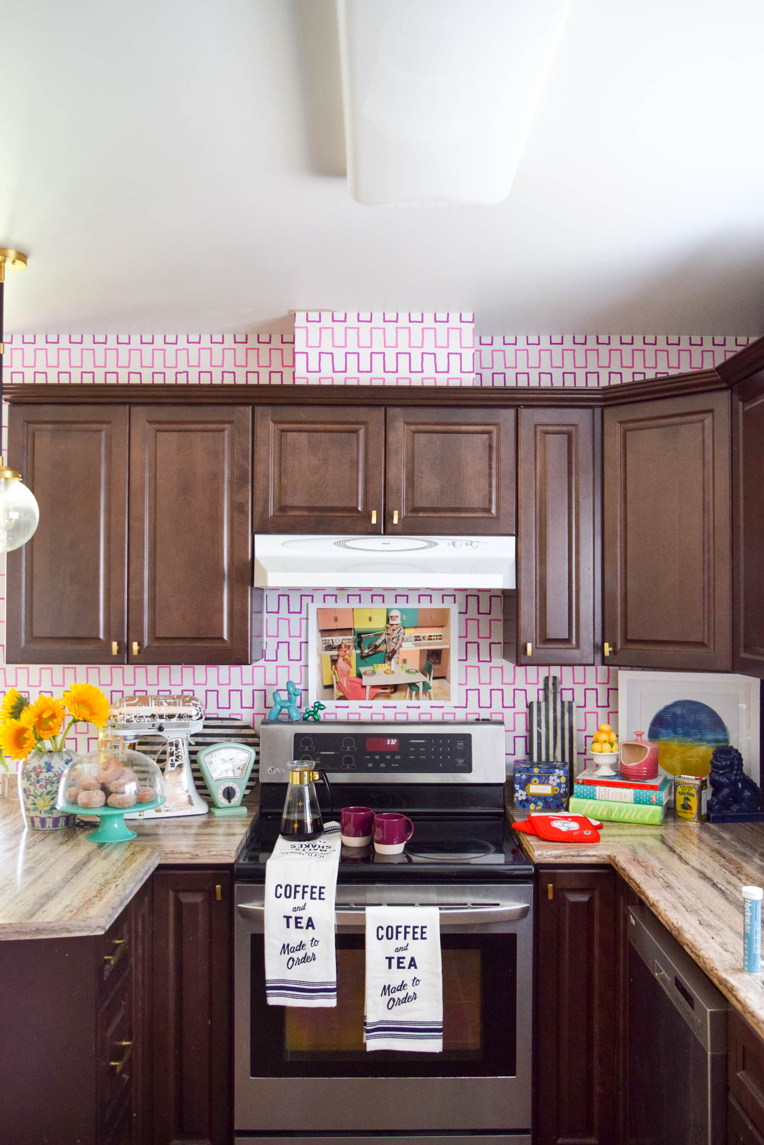 Life is too short to live with ugly rental kitchens. Fix it with a Removable Kitchen Wallpaper Backsplashusing a vibrant pattern from Spoonflower. All you need to get started are the measurements of your space, and the pattern you want! #wallpaper #removablewallpaper #backsplash #renterfriendly #kitchenupgrades