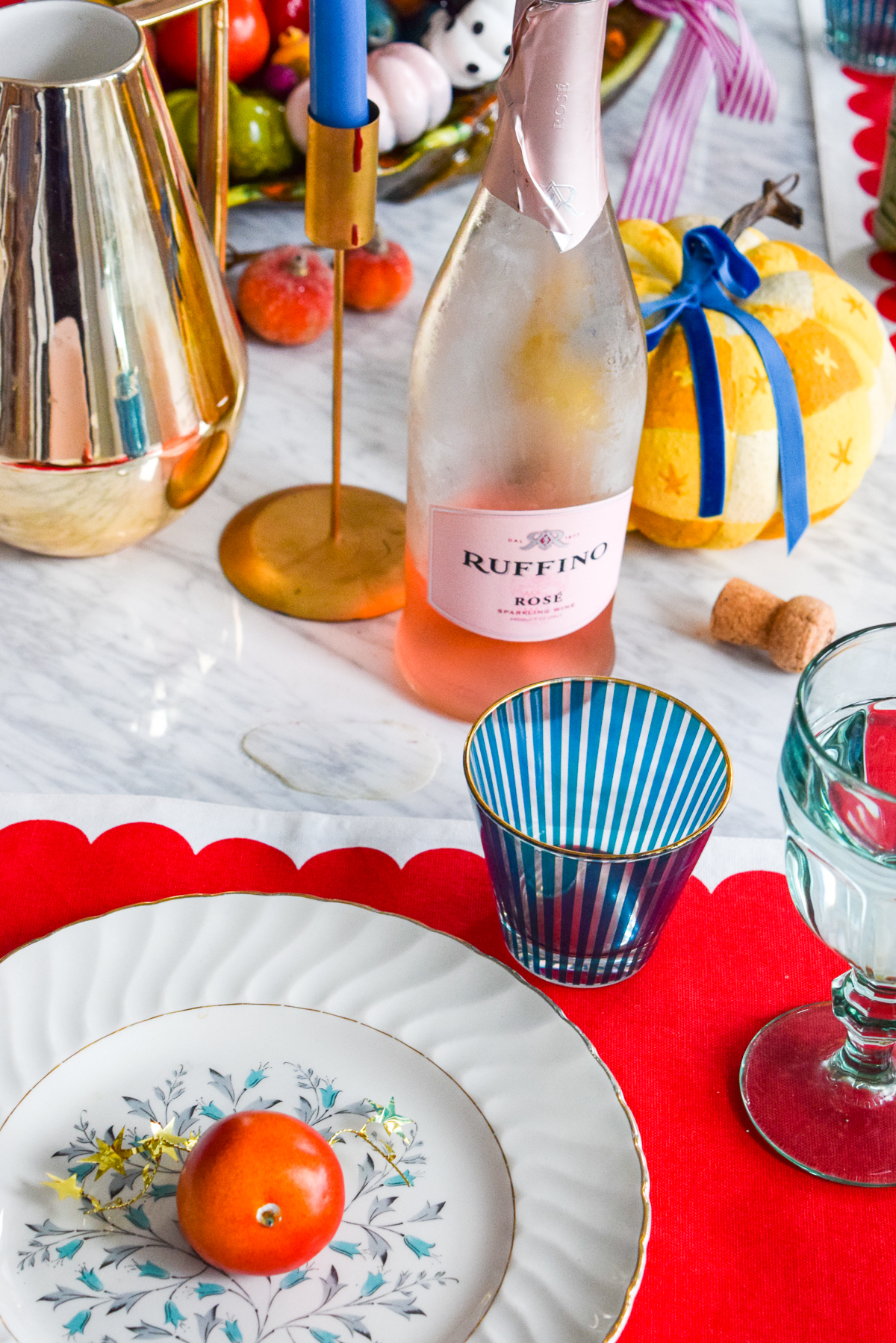 red scalloped kate spade placemat on marble table 