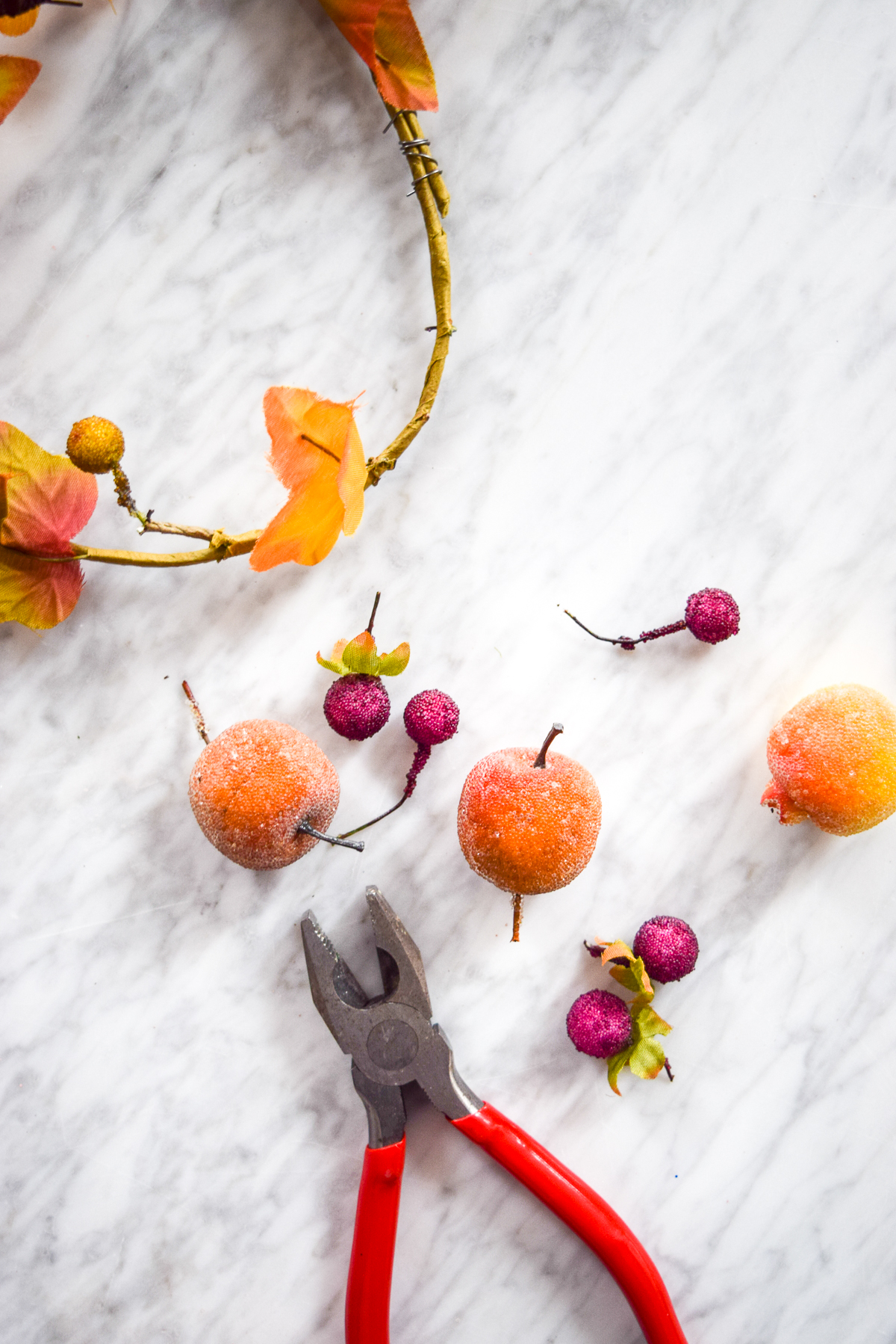 wire snippers on a marble table with fake fruit