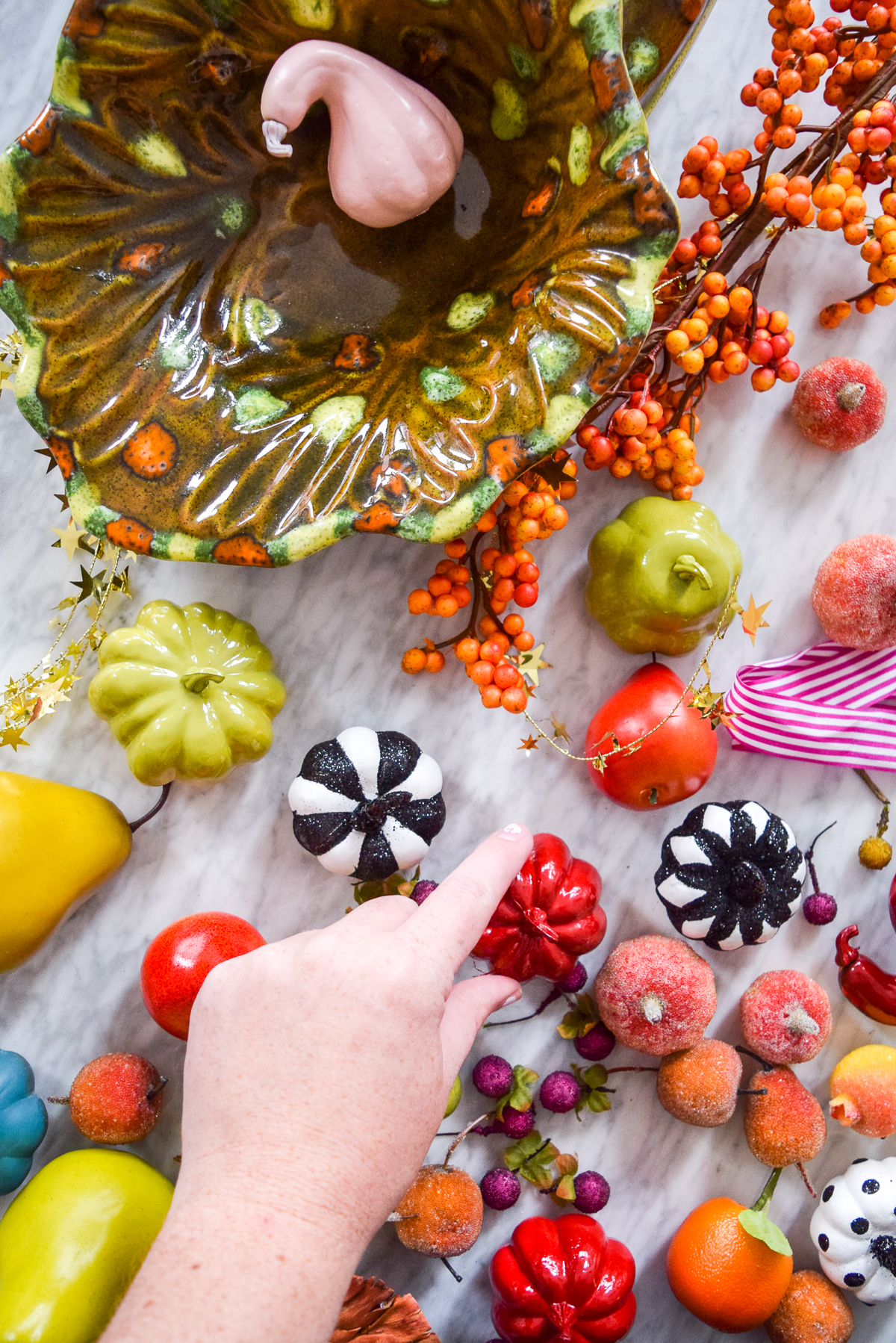 colourful pumpkins and fruit on a marble table