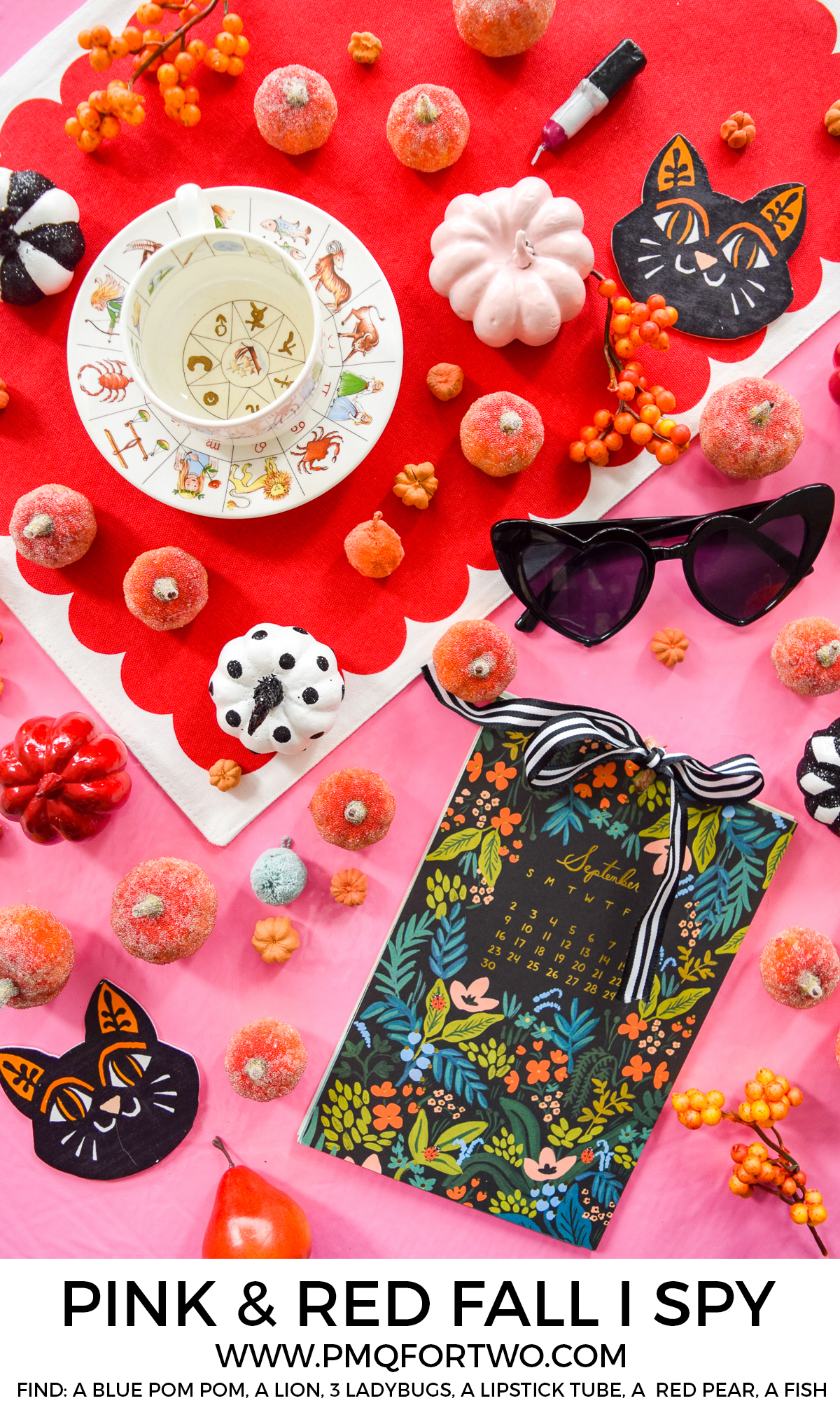 a pink and red flat lay tablescape with a calendar