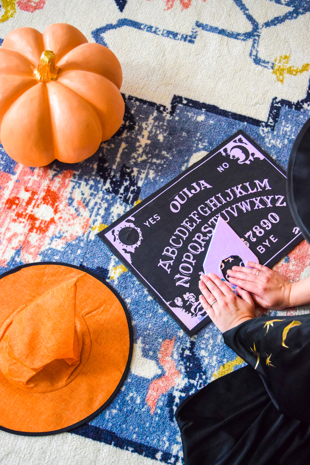 woman moving the planchette on a ouija board