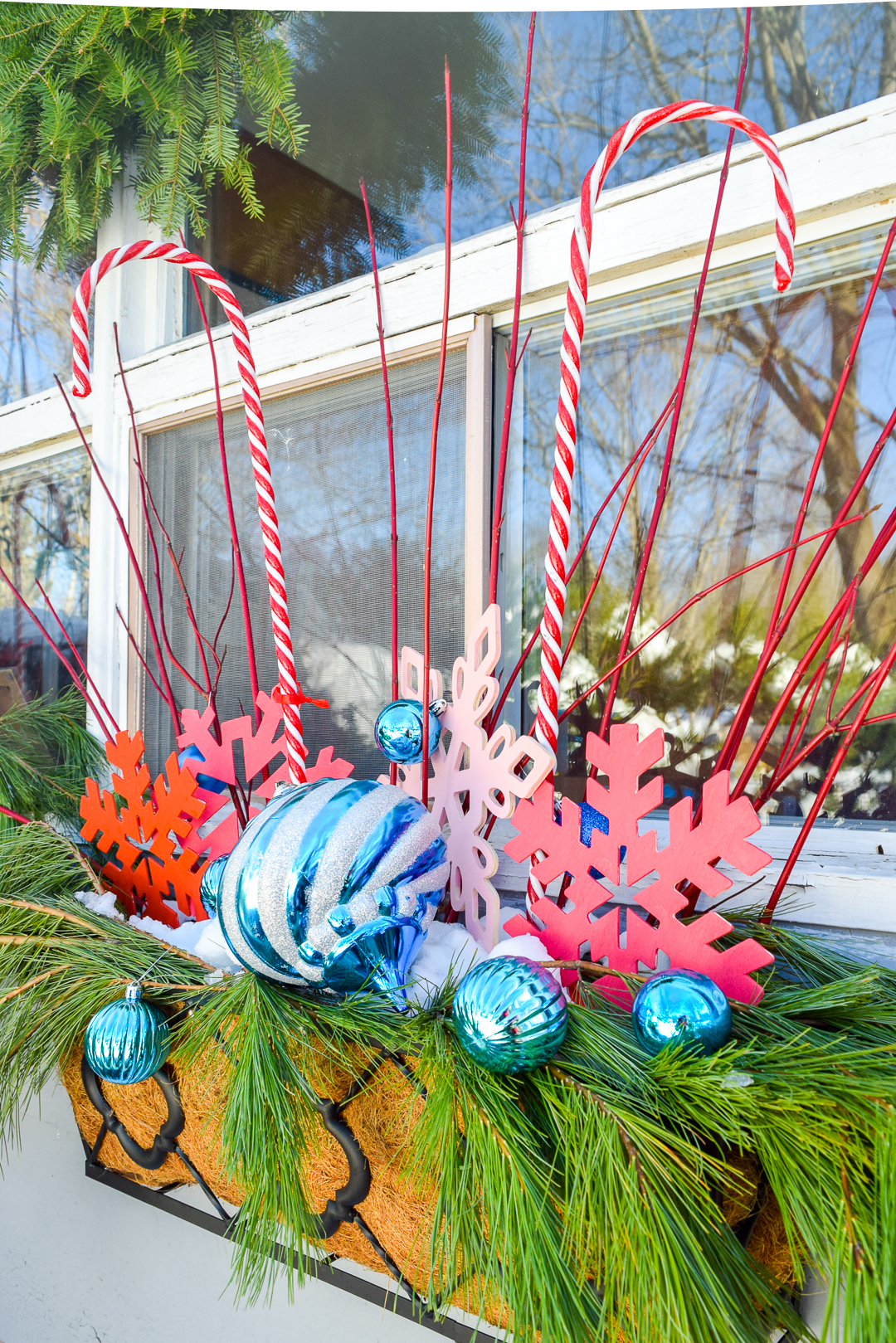 Give your home a classic & colourful holiday porch makeover with the help of Behr paint! Who doesn't need a sexy new black door, and colourful window baskets.