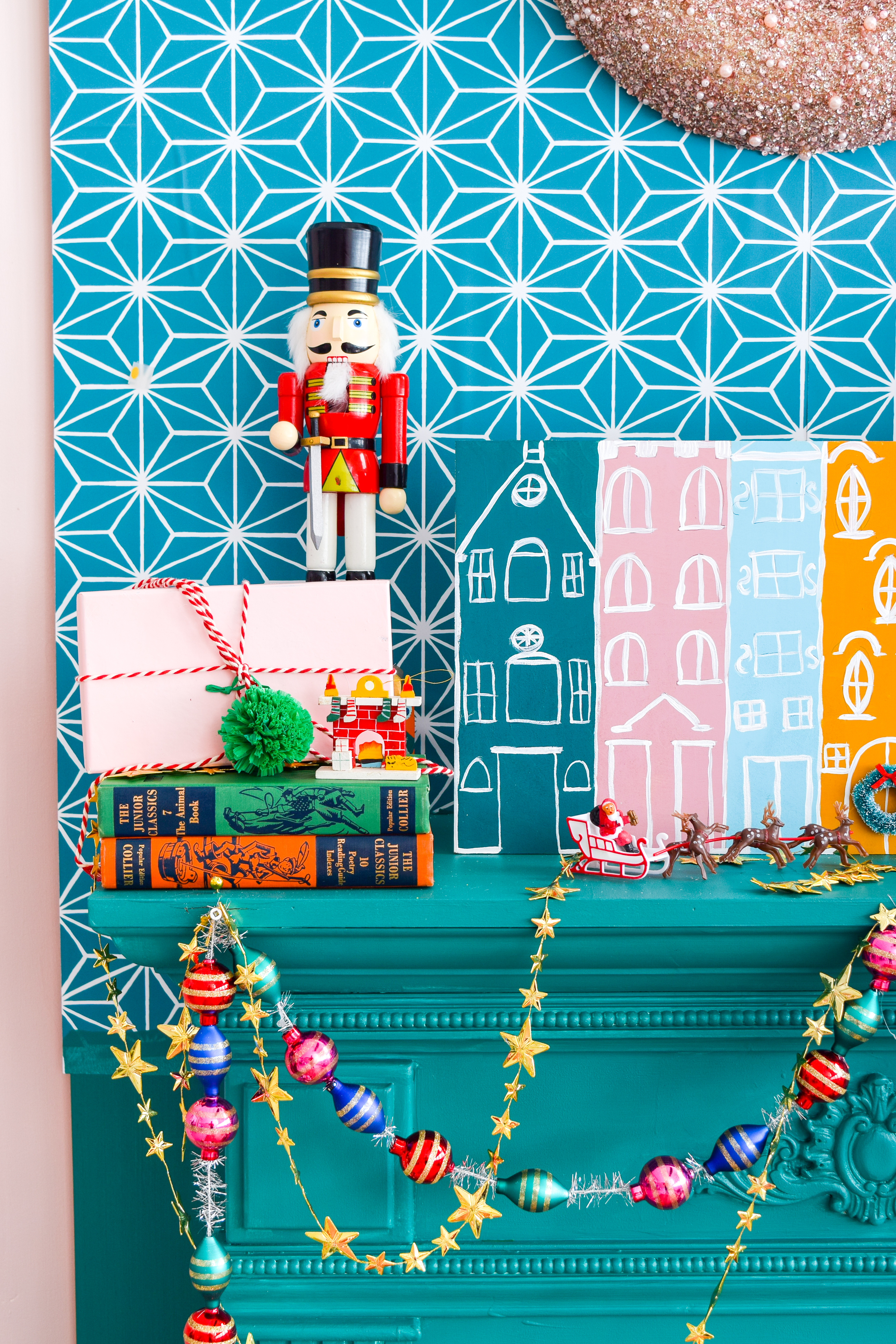A painted Christmas village is all you need to bring a dose of seasonal cheer (and colour!) to your Christmas mantel, sideboard, or console table! Grab your Americana Acrylic Paints & Dazzling Metallics to get started. #christmascraft #christmasvillage 