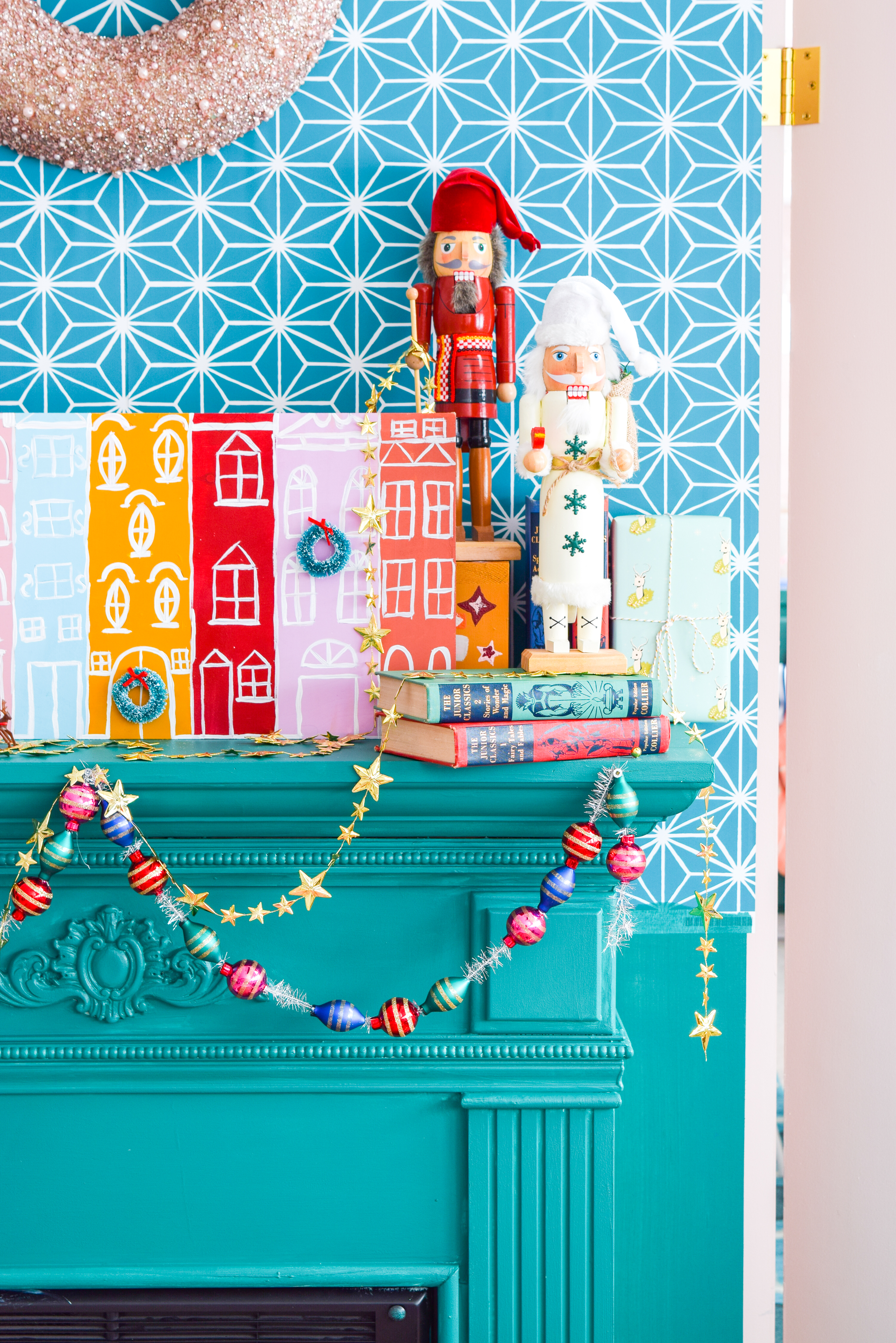 A painted Christmas village is all you need to bring a dose of seasonal cheer (and colour!) to your Christmas mantel, sideboard, or console table! Grab your Americana Acrylic Paints & Dazzling Metallics to get started. #christmascraft #christmasvillage 