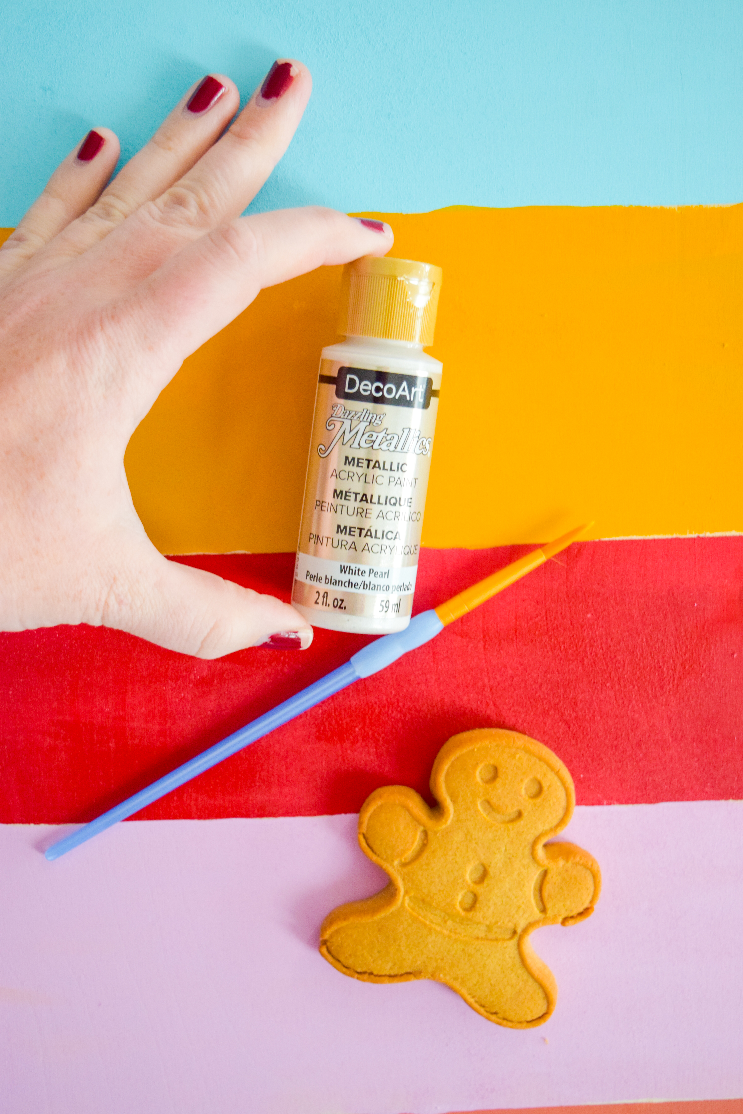 A painted Christmas village is all you need to bring a dose of seasonal cheer (and colour!) to your Christmas mantel, sideboard, or console table! Grab your Americana Acrylic Paints & Dazzling Metallics to get started. #christmascraft #christmasvillage 