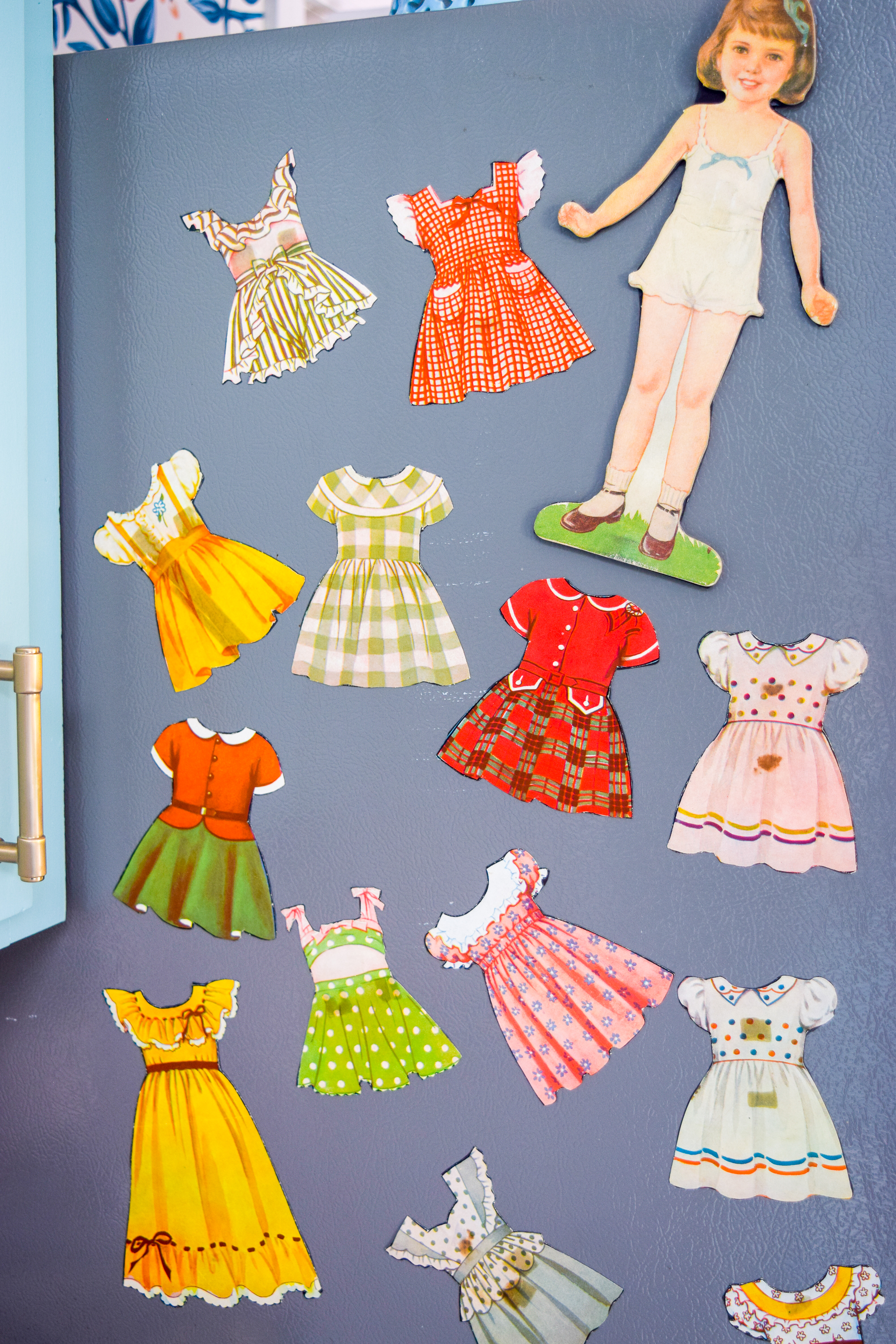 Got an old paper doll set? Add some magnetic sheeting them, and stick them to your fridge for a fun set of DIY retro doll fridge magnets.