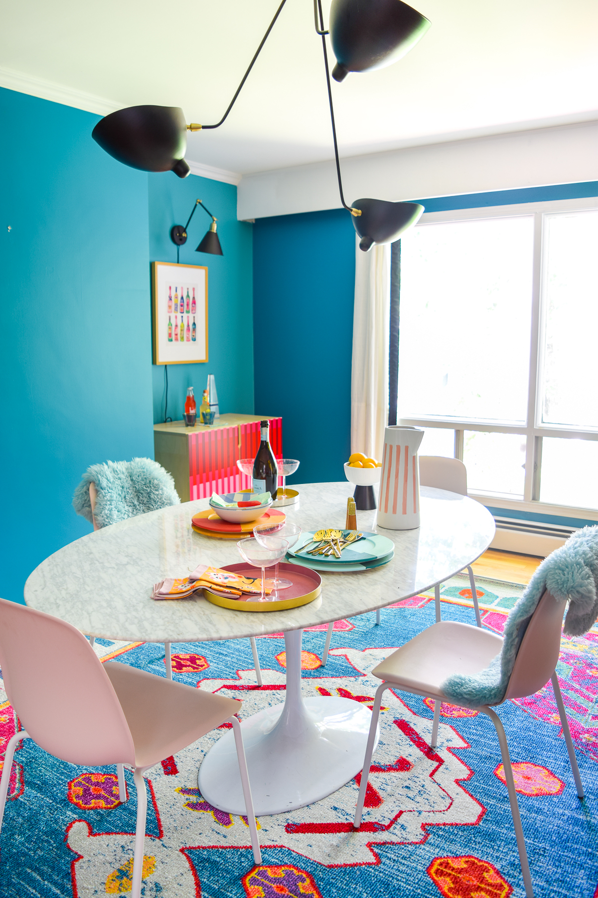 A mid century modern dining room, full of color, teak, marble, and color blocked walls. What's not to love? Come grab inspo and sources on the blog.