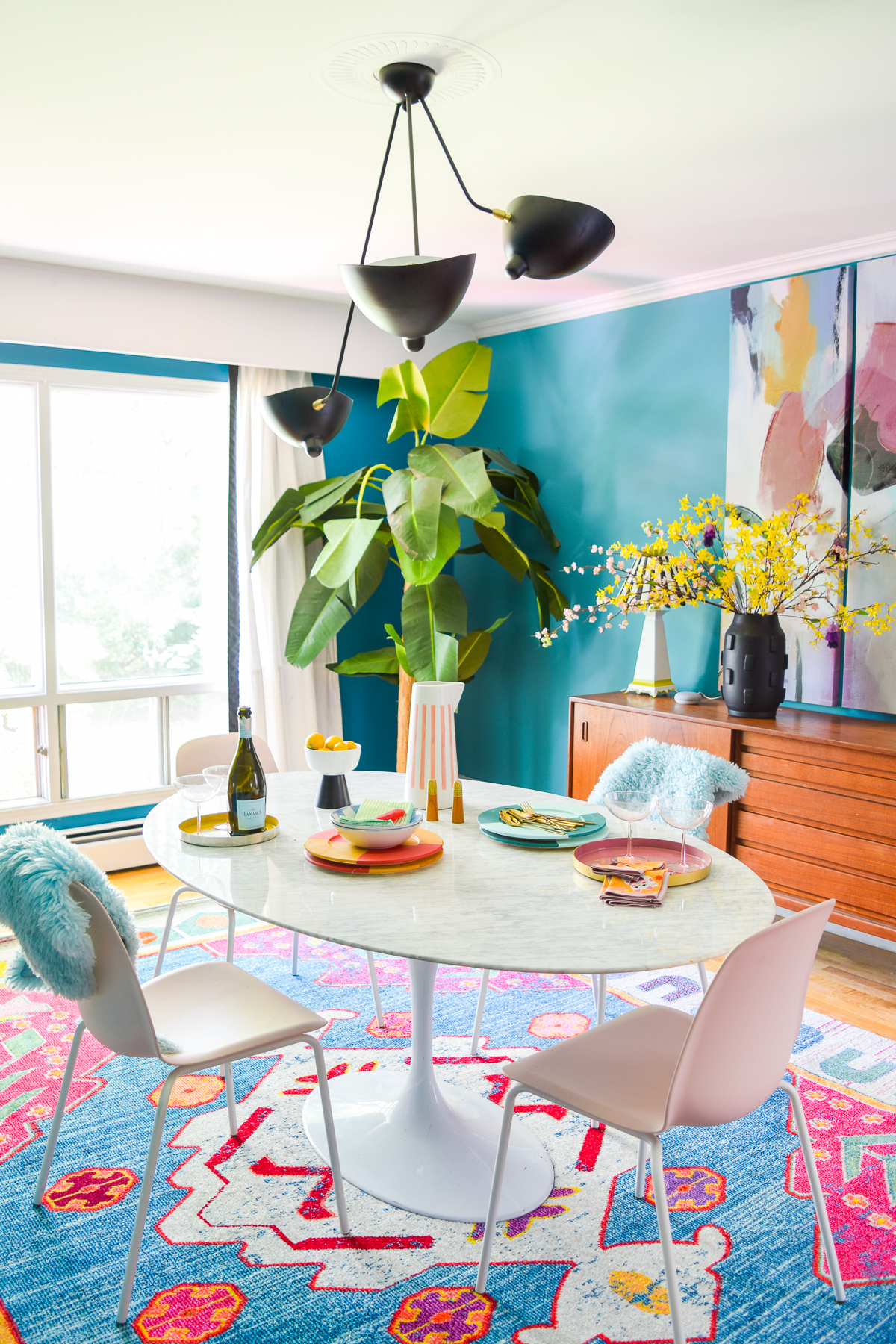 A mid century modern dining room, full of color, teak, marble, and color blocked walls. What's not to love? Come grab inspo and sources on the blog.