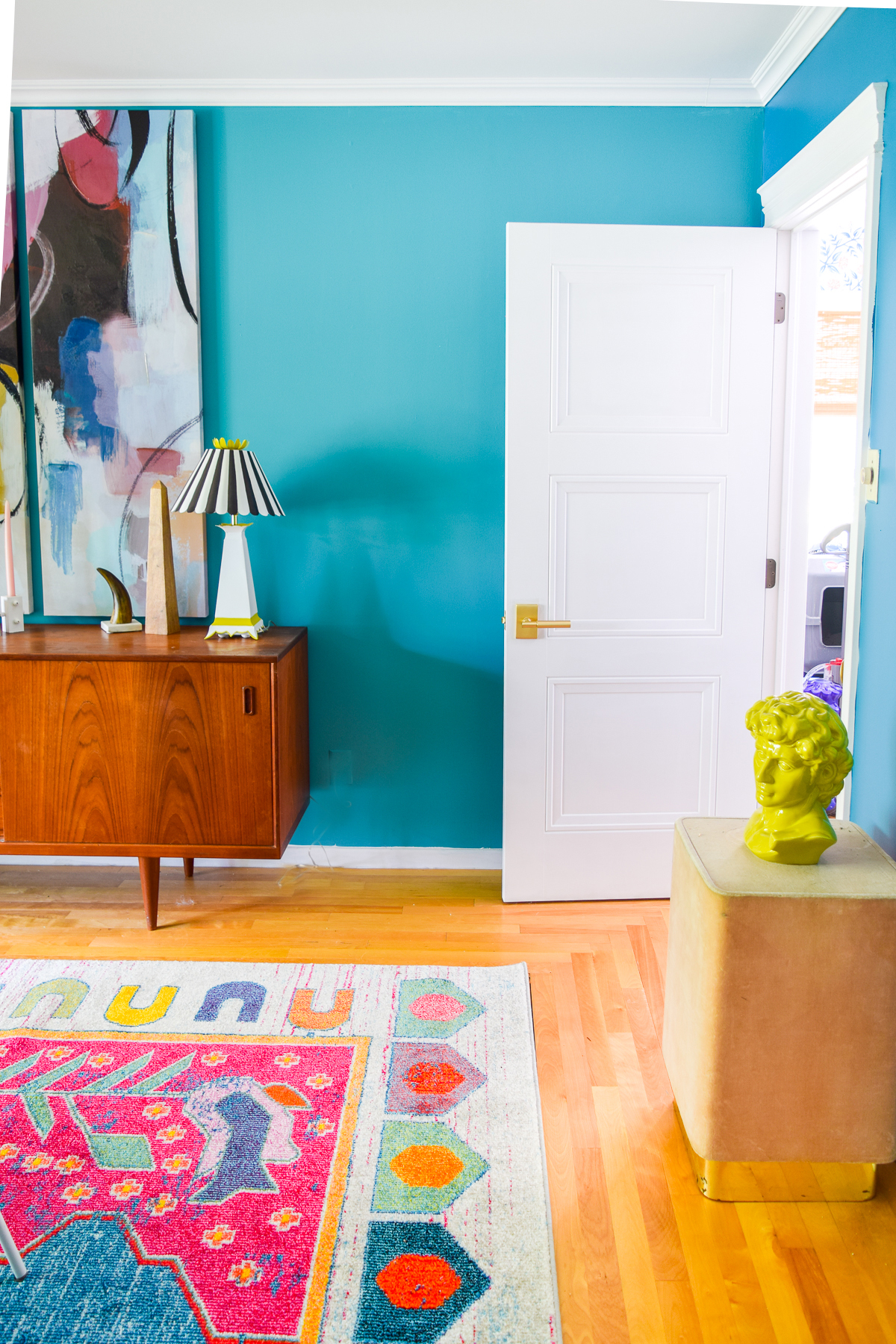 A mid century modern dining room, full of color, teak, marble, and color blocked walls. What's not to love? Come grab inspo and sources on the blog.