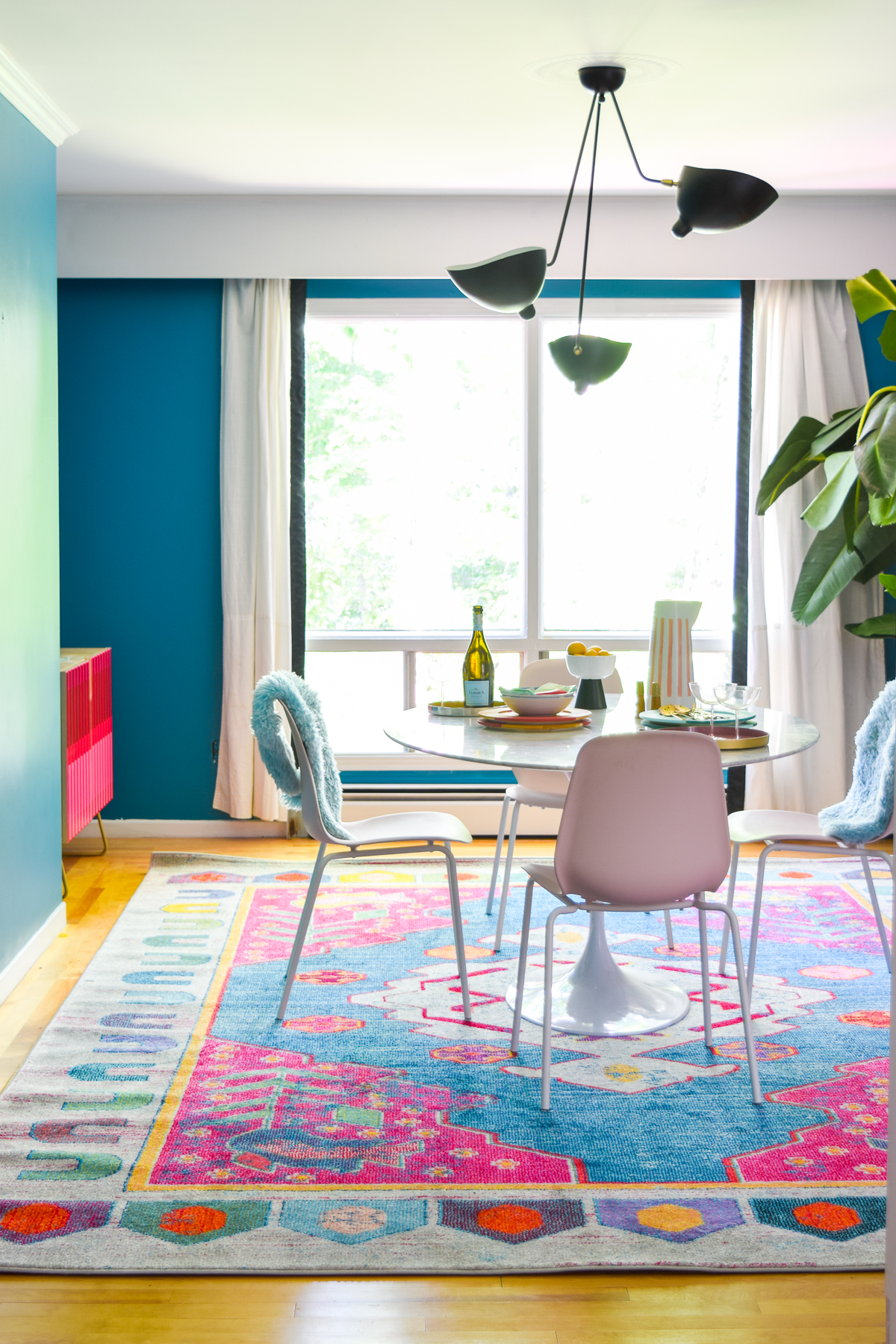 A mid century modern dining room, full of color, teak, marble, and color blocked walls. What's not to love? Come grab inspo and sources on the blog.