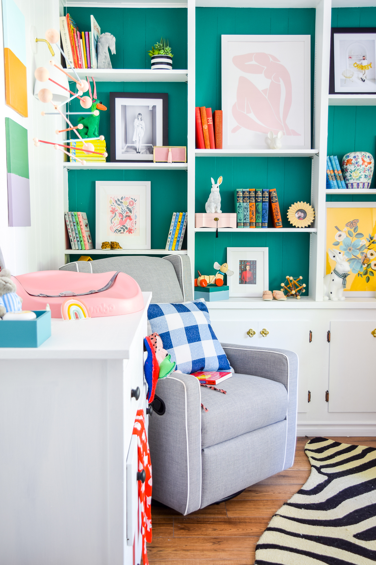 Our colorful baby girl nursery is full of pattern and texture. Between the swan rocker and the oval crib, what's not to love?