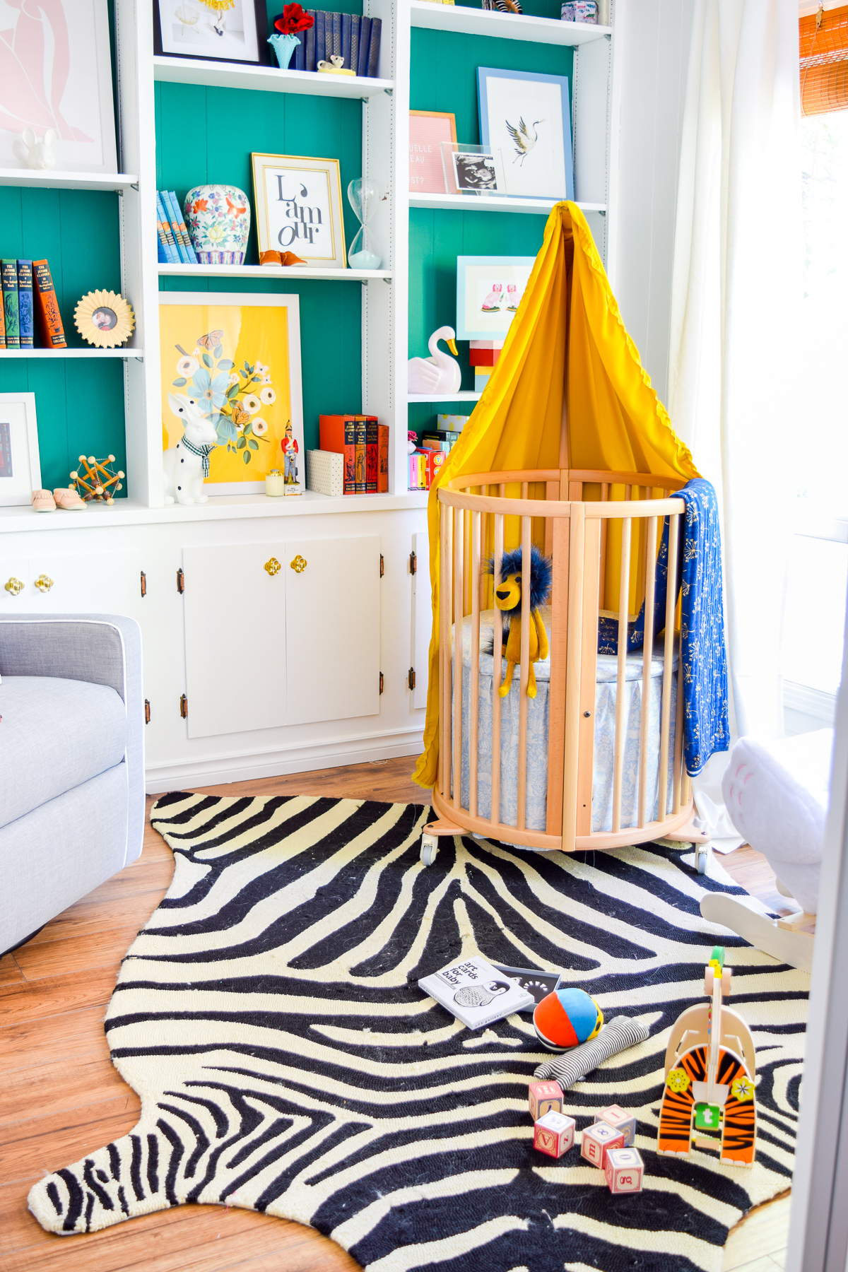 Our colorful baby girl nursery is full of pattern and texture. Between the swan rocker and the oval crib, what's not to love?