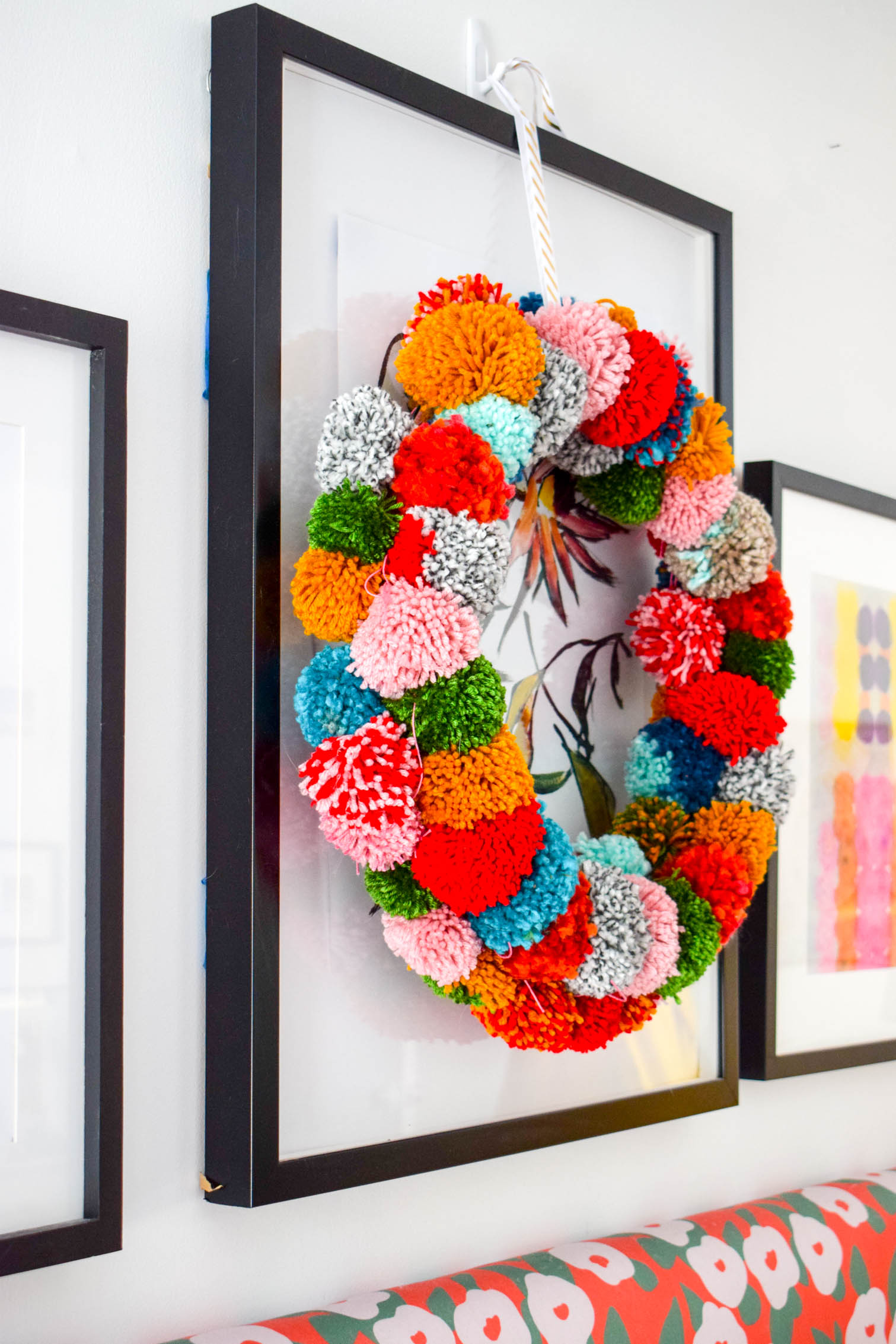 Make your own pom pom wreath this holiday season, and add a bold statement to your decor. This wreath is easy to make and a lot of fun to put together.