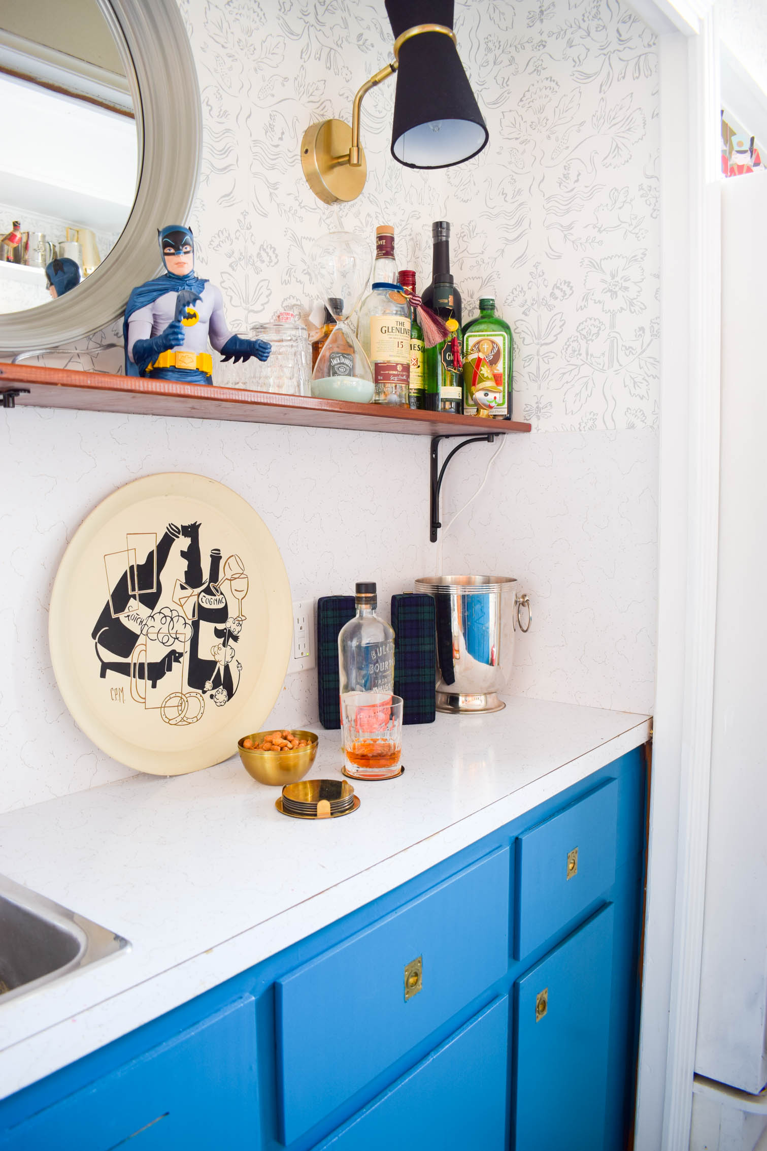 Our basement bar was a nightmare from the 70s, and now it's a clean modern space. With a few budget friendly updates we took it from drab to fab. Freshly painted cabinets, peel and stick floor tiles, and new wallpaper are just what the space needed!