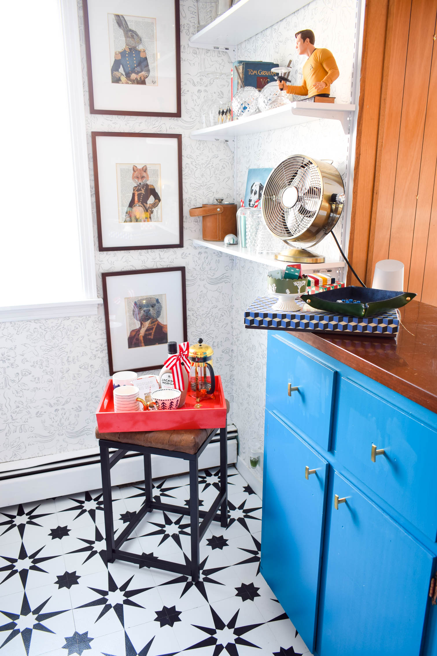 Our basement bar was a nightmare from the 70s, and now it's a clean modern space. With a few budget friendly updates we took it from drab to fab. Freshly painted cabinets, peel and stick floor tiles, and new wallpaper are just what the space needed!