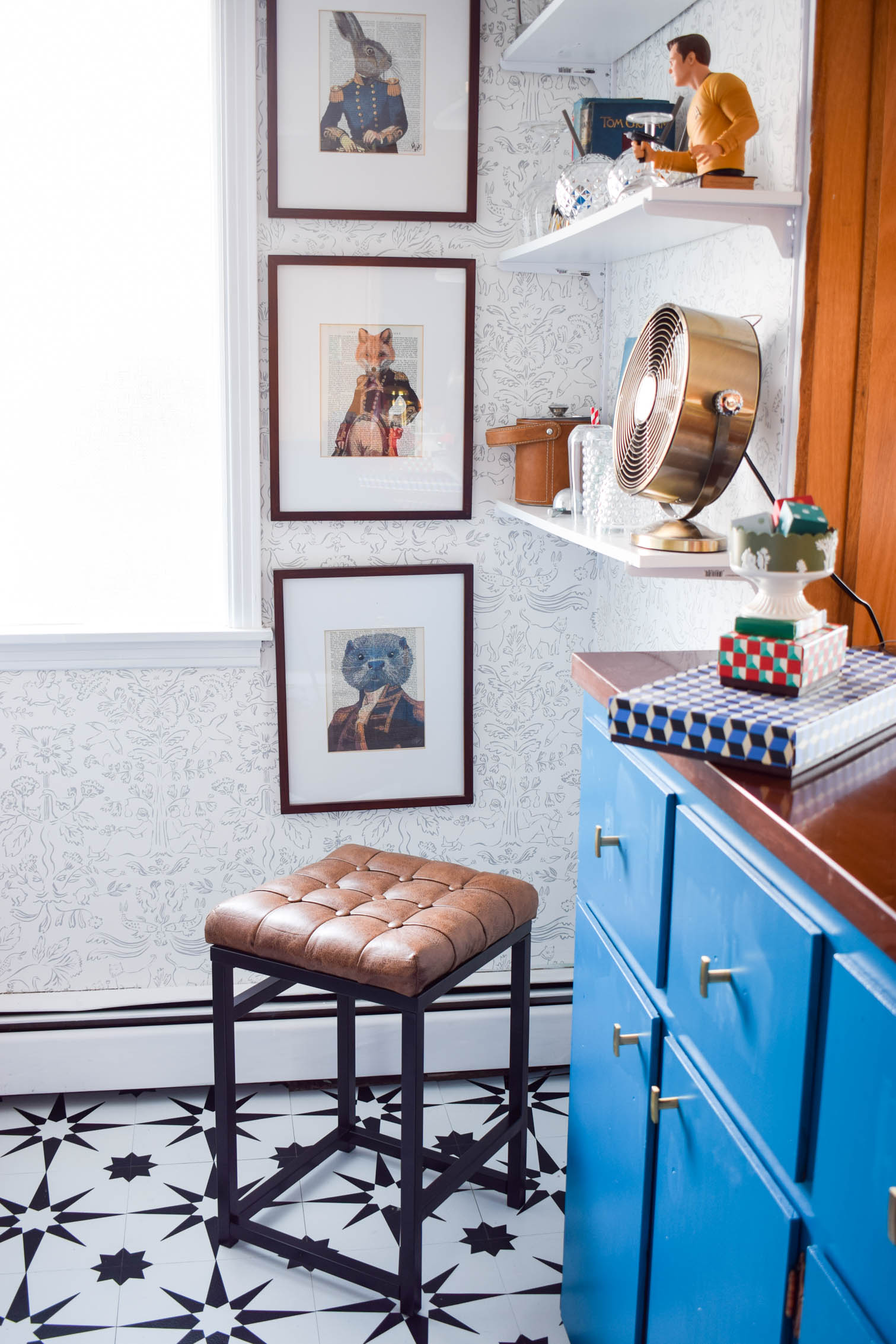 Our basement bar was a nightmare from the 70s, and now it's a clean modern space. With a few budget friendly updates we took it from drab to fab. Freshly painted cabinets, peel and stick floor tiles, and new wallpaper are just what the space needed!