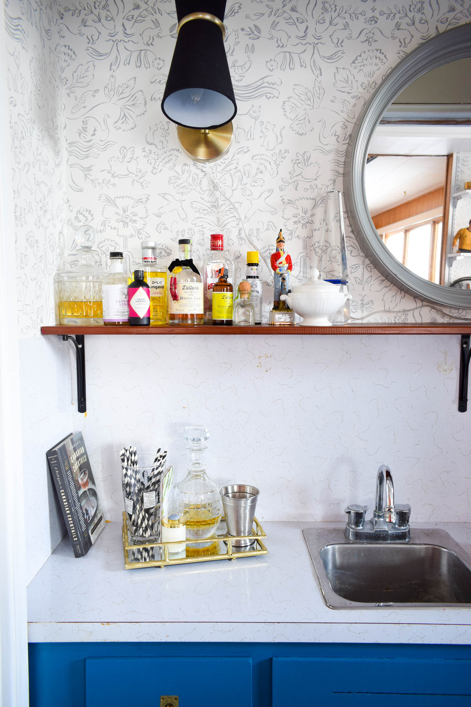 Our basement bar was a nightmare from the 70s, and now it's a clean modern space. With a few budget friendly updates we took it from drab to fab. Freshly painted cabinets, peel and stick floor tiles, and new wallpaper are just what the space needed!