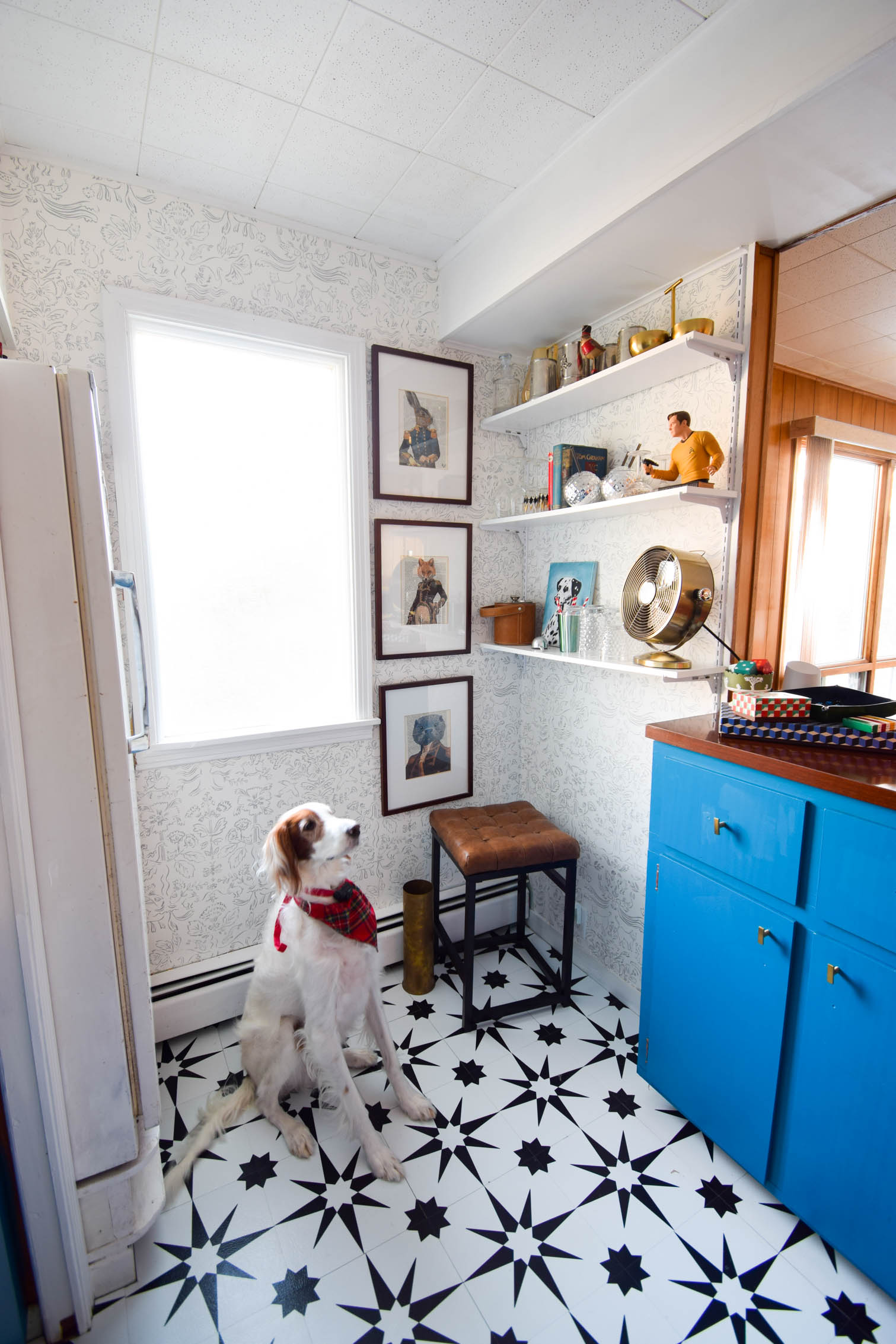 Our basement bar was a nightmare from the 70s, and now it's a clean modern space. With a few budget friendly updates we took it from drab to fab. Freshly painted cabinets, peel and stick floor tiles, and new wallpaper are just what the space needed!