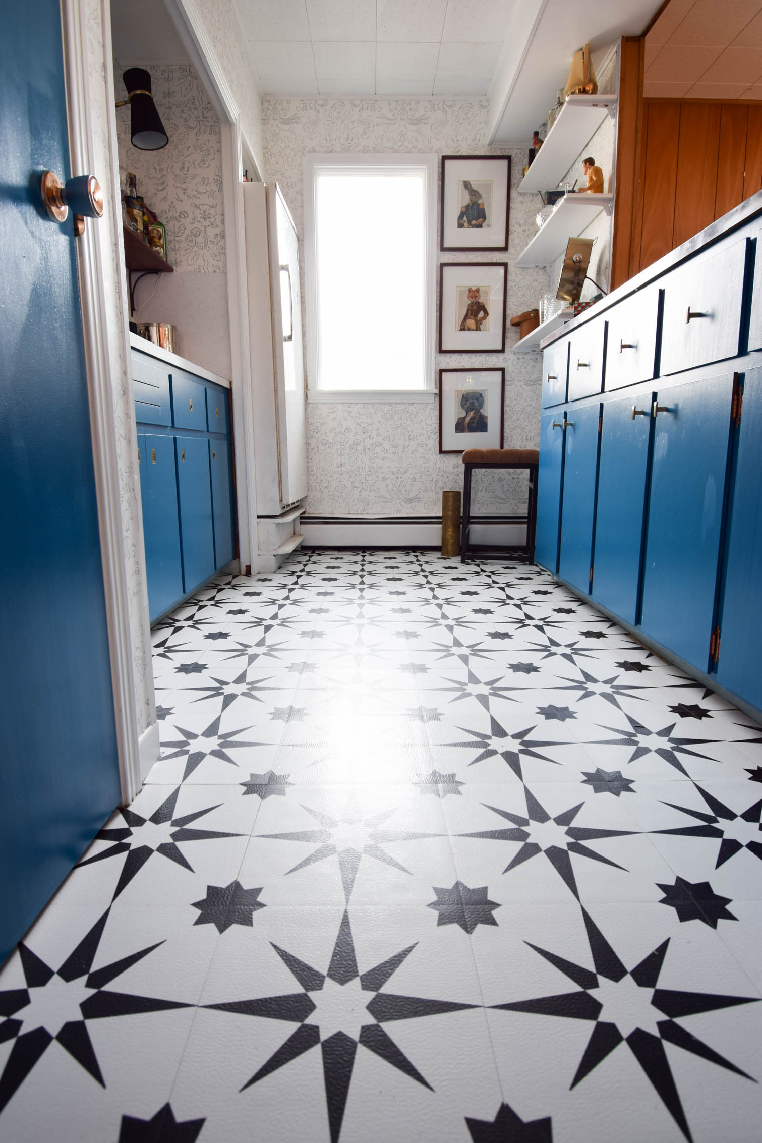 Our basement bar was a nightmare from the 70s, and now it's a clean modern space. With a few budget friendly updates we took it from drab to fab. Freshly painted cabinets, peel and stick floor tiles, and new wallpaper are just what the space needed!