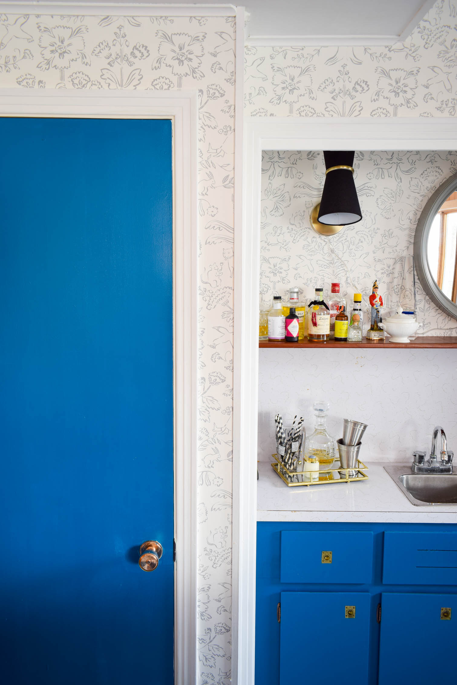 Our basement bar was a nightmare from the 70s, and now it's a clean modern space. With a few budget friendly updates we took it from drab to fab. Freshly painted cabinets, peel and stick floor tiles, and new wallpaper are just what the space needed!